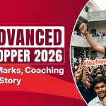 "JEE Advanced Sikar Topper 2026 celebration poster featuring a joyful student wearing orange marigold garlands being carried by friends, with a large crowd cheering in the background. Text highlights 'JEE Advanced Sikar Topper 2026' along with AIR Rank, Marks, Coaching & Success Story."